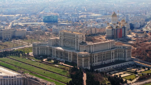 Aerial drone view of Palace of the Parliament in Bucharest downtown in sunlight. Romania - Starpik Stock