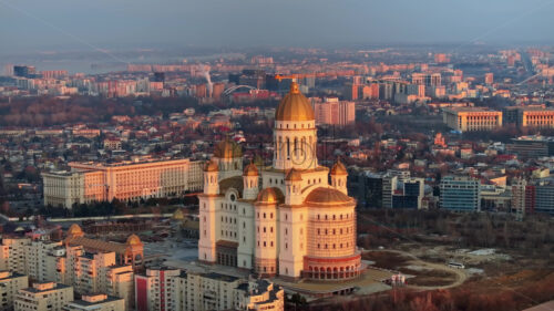 Aerial drone view of People’s Salvation Cathedral near the Palace of the Parliament. Sunset in Bucharest, Romania - Starpik Stock