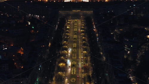 Aerial drone view of illuminated Palace of the Parliament in Bucharest downtown in the evening. mp4ing traffic on the road. Romania - Starpik Stock