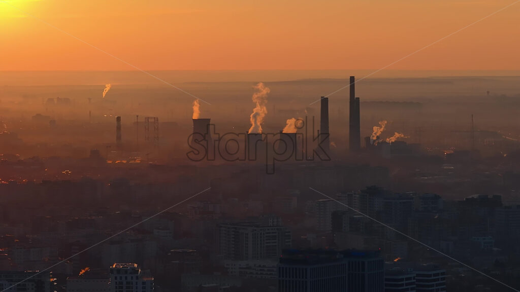 Aerial drone view of thermal power stations in Bucharest at sunset. Flying birds. Romania - Starpik Stock