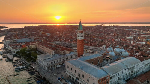 Video Aerial drone view of St Mark’s Campanile with Venice, Italy on the background, at sunset - Starpik Stock