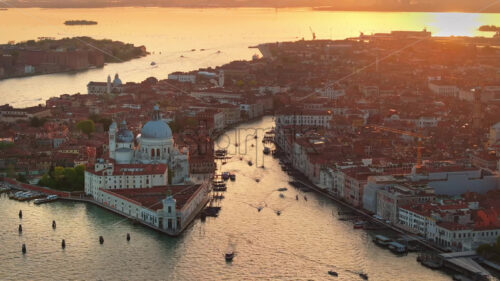 Video Aerial drone view of boats moving through Venice City, Italy, at sunset - Starpik Stock
