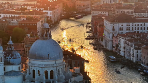 Video Aerial drone view of boats moving through Venice City, Italy, at sunset - Starpik Stock