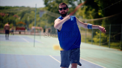 Video Man and woman wearing sunglasses doing a secret handshake after playing pickleball - Starpik Stock