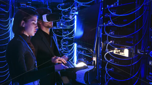 Video – Royalty free stock video Woman programming in a server room while a man is using a Virtual Reality headset - Starpik Stock