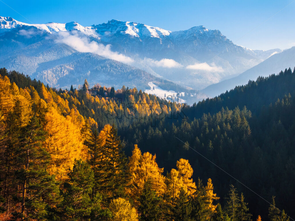 Aerial drone view of Bucegi Mountains in autumn season with blue sky. Romania - Starpik
