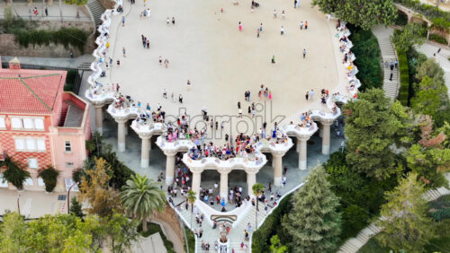 Video Aerial drone view of Park Guell. Antoni Gaudi architecture. A lot of greenery around, tourists, Barcelona, Spain, Download royalty free stock footage