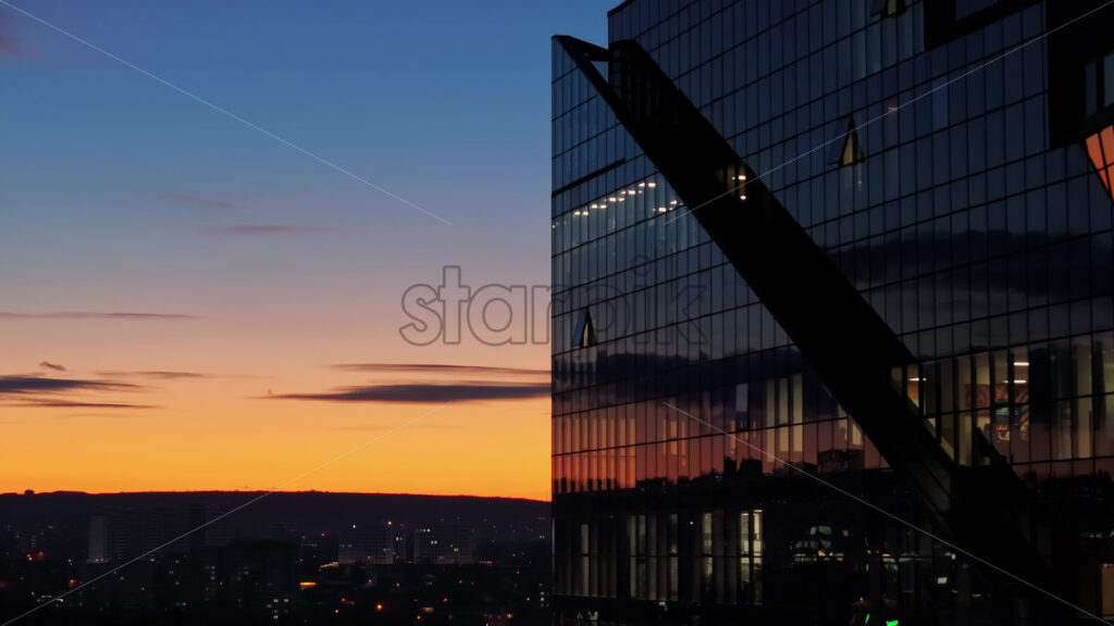 Video Aerial drone view of a glass building in Chisinau, Moldova at sunset - Starpik