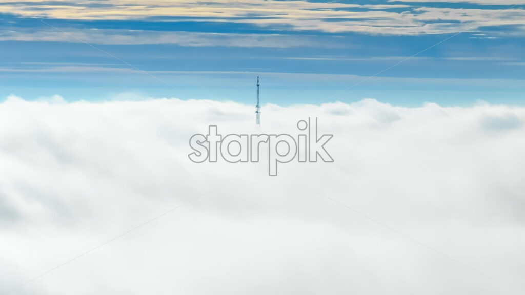 Video Aerial drone view of an utility pole in the clouds - Starpik