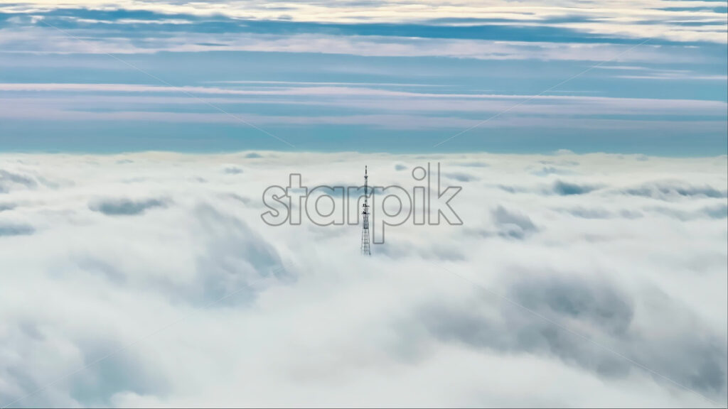 Video Aerial drone view of an utility pole in the clouds - Starpik