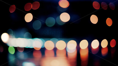 Video Blurry, circular light patterns in various warm and cool tones, set against a dark background