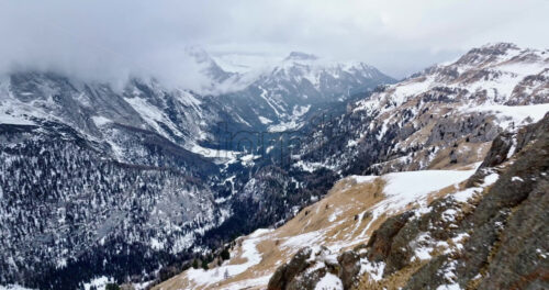 Aerial drone view of Portavescovo covered in snow, in Arabba, Italy - Starpik Stock