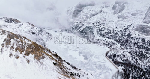 Aerial drone view of Portavescovo covered in snow, in Arabba, Italy - Starpik Stock