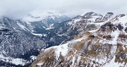 Aerial drone view of Portavescovo covered in snow, in Arabba, Italy - Starpik Stock