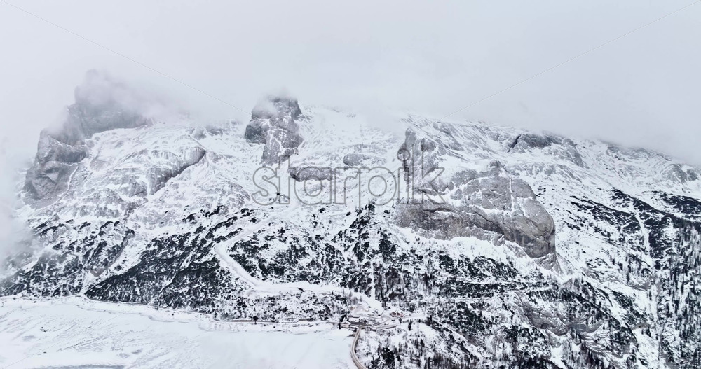 Aerial drone view of Portavescovo covered in snow, in Arabba, Italy - Starpik Stock
