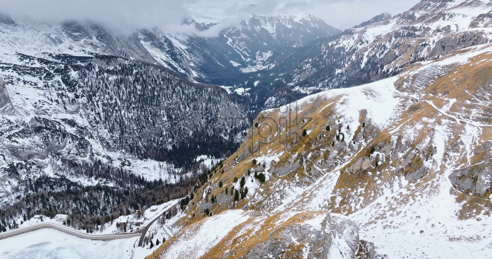 Aerial drone view of Portavescovo covered in snow, in Arabba, Italy - Starpik Stock