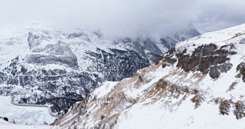 Aerial drone view of Portavescovo covered in snow, in Arabba, Italy - Starpik Stock