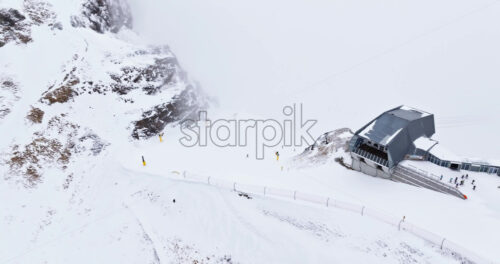 Aerial drone view of Portavescovo covered in snow, in Arabba, Italy - Starpik Stock