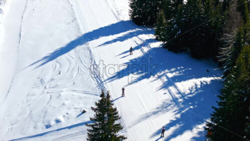 Aerial drone view of a ski resort in Col dei Baldi, Alleghe, in the Dolomites, Italy in daylight - Starpik Stock