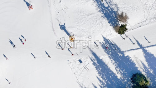 Aerial drone view of a ski resort in Col dei Baldi, Alleghe, in the Dolomites, Italy in daylight - Starpik Stock