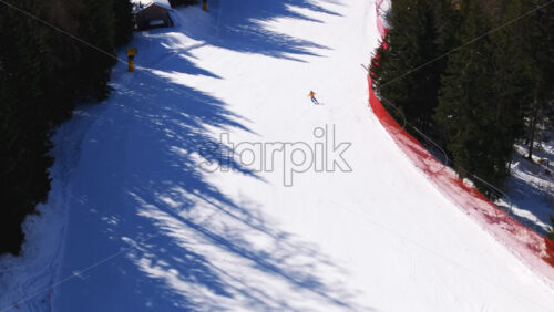 Aerial drone view of a ski resort in Piani di Pezze, Alleghe, Province of Belluno, in the Dolomites, Italy in daylight - Starpik Stock