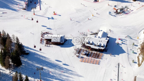 Aerial drone view of a ski resort in Piani di Pezze, Alleghe, Province of Belluno, in the Dolomites, Italy in daylight - Starpik Stock