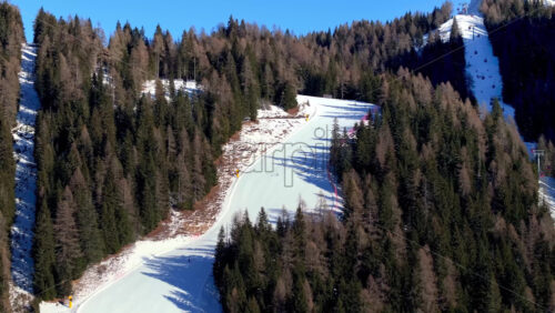Aerial drone view of a ski resort in Piani di Pezze, Alleghe, Province of Belluno, in the Dolomites, Italy in daylight - Starpik Stock
