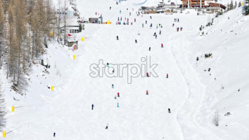Aerial drone view of people skiing in Colfosco in South Tyrol, Dolomites, Northern Italy - Starpik Stock