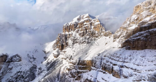 Aerial drone view of snow on the Sassongher mountain in the Dolomites, Italy - Starpik Stock