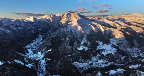 Aerial drone view of snow on the mountains in the Dolomites, Italy - Starpik Stock