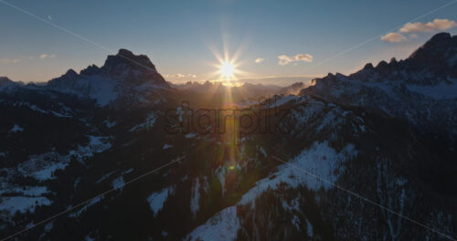Aerial drone view of snow on the mountains in the Dolomites, Italy - Starpik Stock