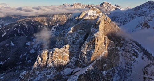 Aerial drone view of snow on the mountains in the Dolomites, Italy - Starpik Stock