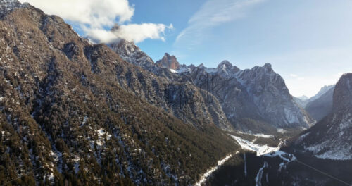 Aerial drone view of snow on the mountains in the Dolomites, Italy - Starpik Stock