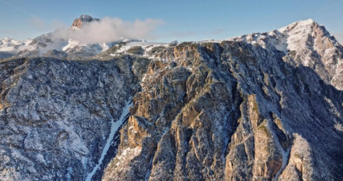 Aerial drone view of snow on the mountains in the Dolomites, Italy - Starpik Stock