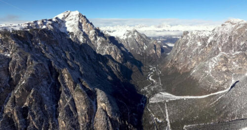Aerial drone view of snow on the mountains in the Dolomites, Italy - Starpik Stock