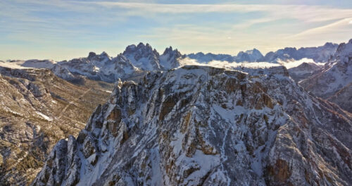 Aerial drone view of snow on the mountains in the Dolomites, Italy - Starpik Stock