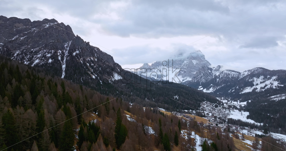 Aerial drone view of snow on the mountains in the Dolomites, Italy - Starpik Stock