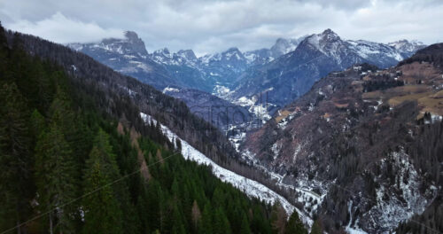 Aerial drone view of snow on the mountains in the Dolomites, Italy - Starpik Stock