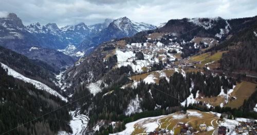 Aerial drone view of snow on the mountains in the Dolomites, Italy - Starpik Stock
