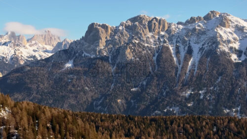 Aerial drone view of snow on the mountains in the Dolomites, Italy - Starpik Stock
