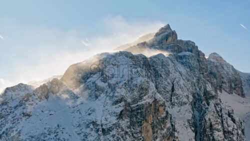 Aerial drone view of snow on the mountains in the Dolomites, Italy - Starpik Stock
