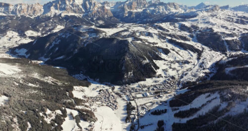 Aerial drone view of the Colfosco mountain village covered in snow, in South Tyrol, Dolomites, Northern Italy - Starpik Stock