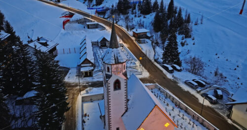 Aerial drone view of the Corvara village covered in snow at blue hour, in South Tyrol, Dolomites, in northern Italy - Starpik Stock