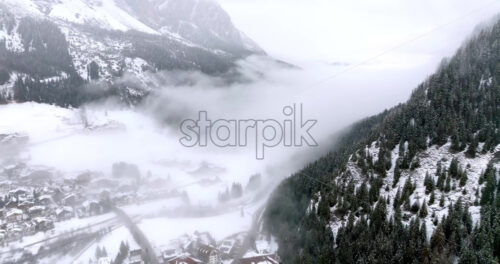 Aerial drone view of the Corvara village covered in snow, in South Tyrol, Dolomites, in northern Italy - Starpik Stock