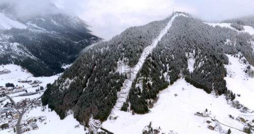 Aerial drone view of the Corvara village covered in snow, in South Tyrol, Dolomites, in northern Italy - Starpik Stock