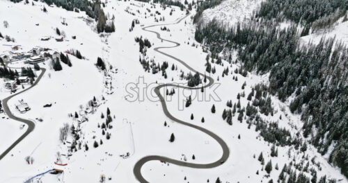 Aerial drone view of the Corvara village covered in snow, in South Tyrol, Dolomites, in northern Italy - Starpik Stock