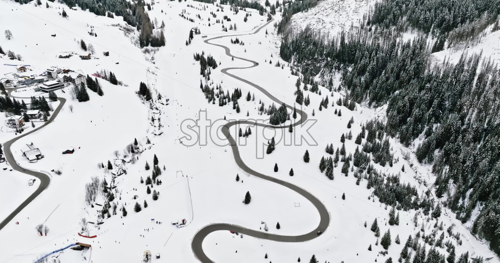 Aerial drone view of the Corvara village covered in snow, in South Tyrol, Dolomites, in northern Italy - Starpik Stock