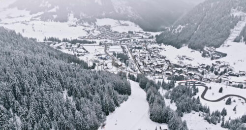 Aerial drone view of the Corvara village covered in snow, in South Tyrol, Dolomites, in northern Italy - Starpik Stock