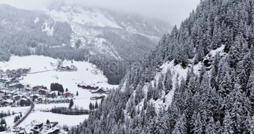 Aerial drone view of the Corvara village covered in snow, in South Tyrol, Dolomites, in northern Italy - Starpik Stock