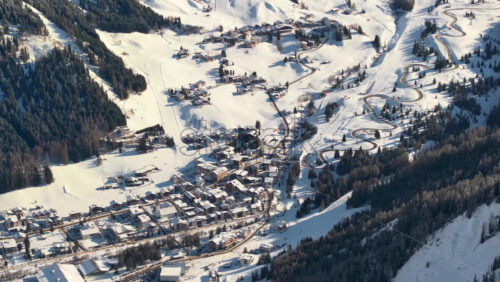 Aerial drone view of the Corvara village covered in snow, in South Tyrol, Dolomites, in northern Italy - Starpik Stock
